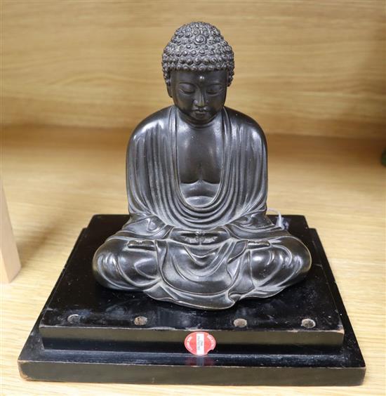 A Japanese Meiji period bronze Buddha, on stepped ebonised plinth, overall height 18cm